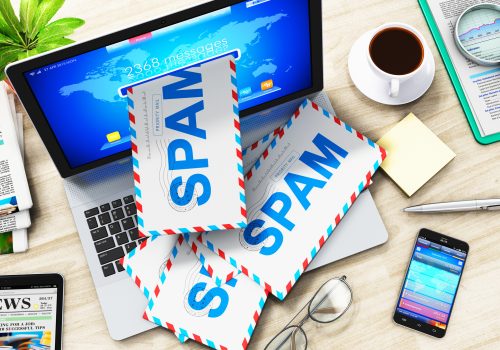 Trapped in spam folder Envelopes marked as spam fall out of a laptop's screen.